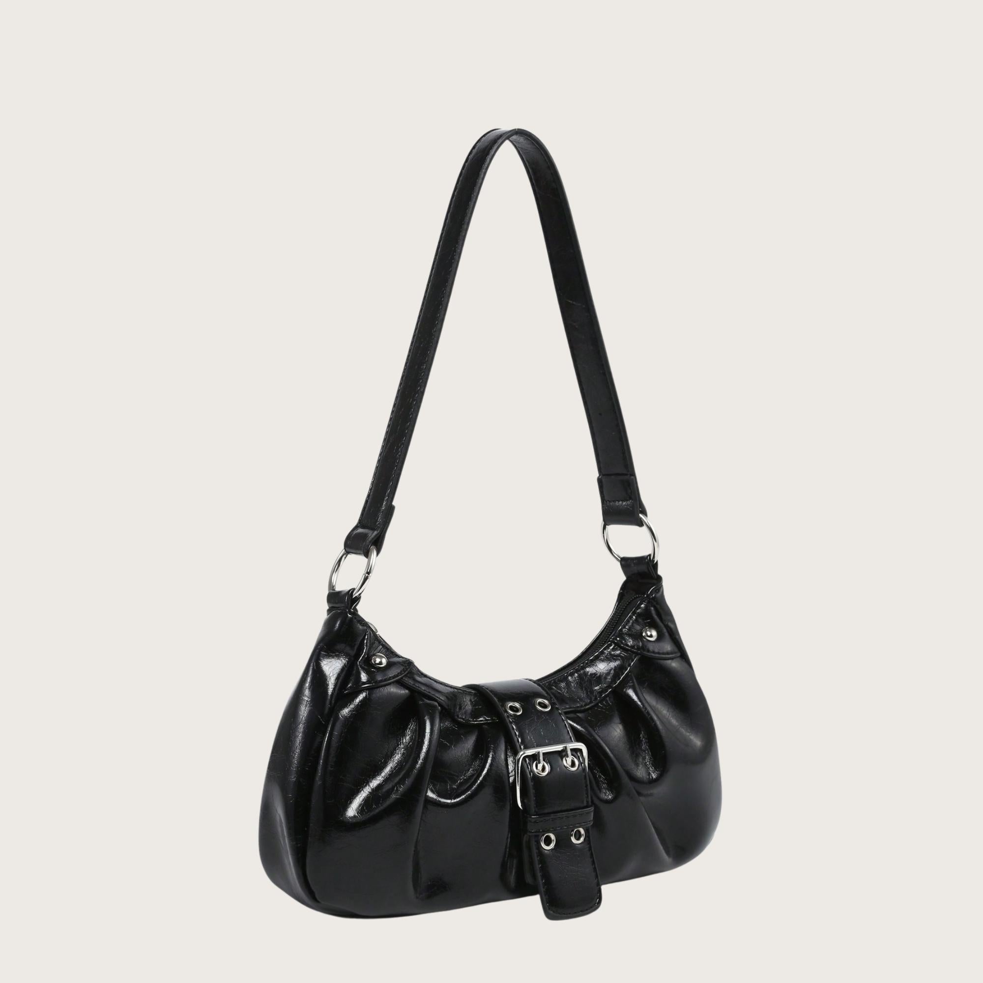 Black handbag with a strap on a light gray background